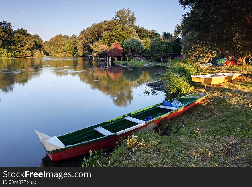 Small Danube in Slovakia with watermill and boat. Small Danube in Slovakia with watermill and boat.