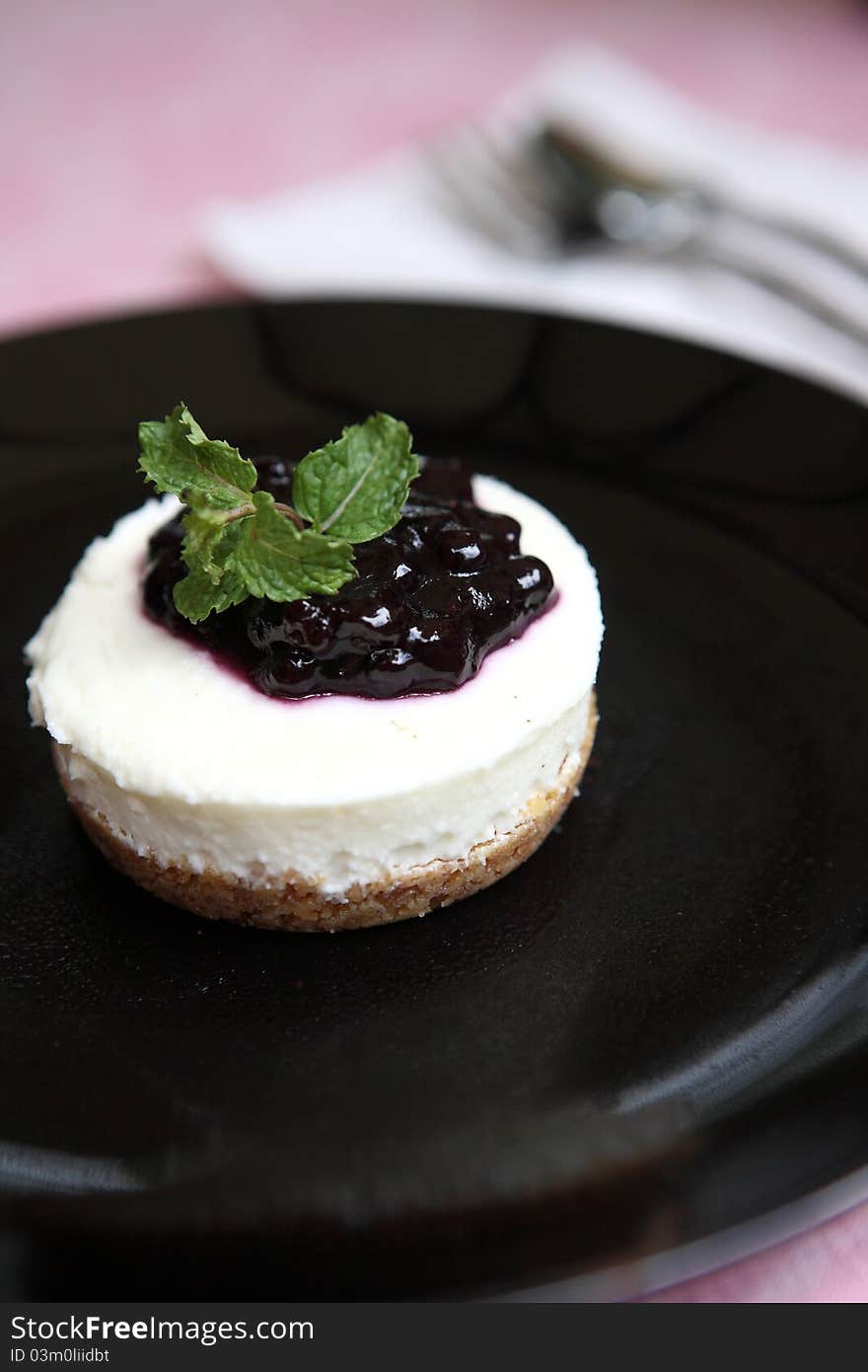 Blueberry cheesecake on black dish