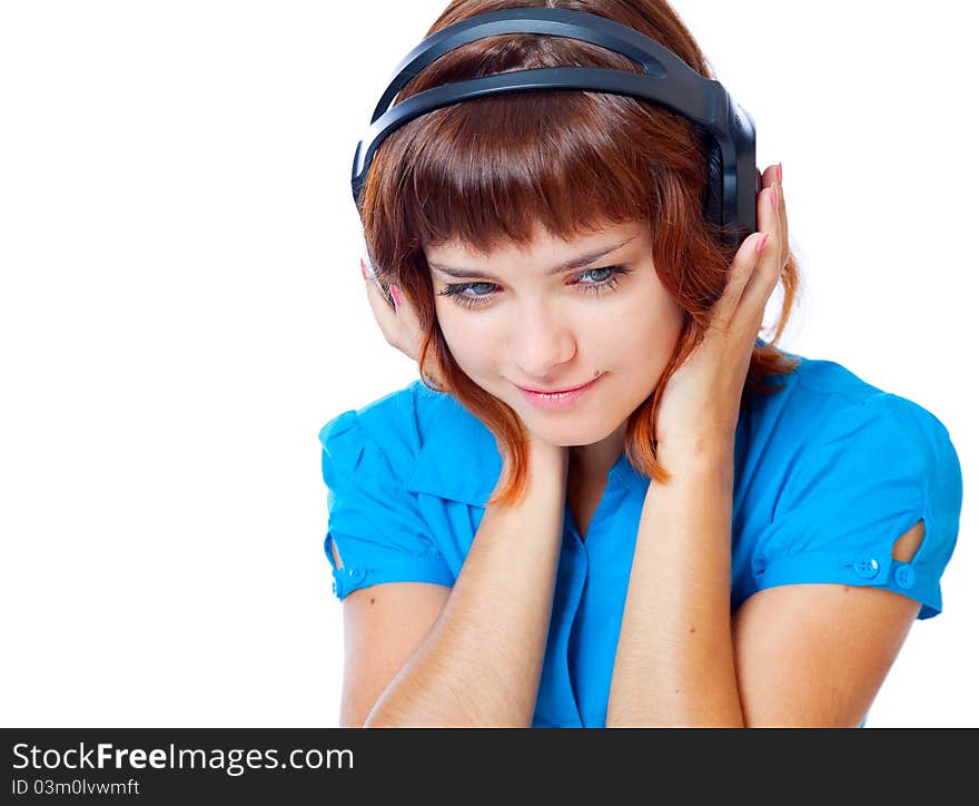 Red-haired teen-girl listen to music in headphones. Isolated on white background