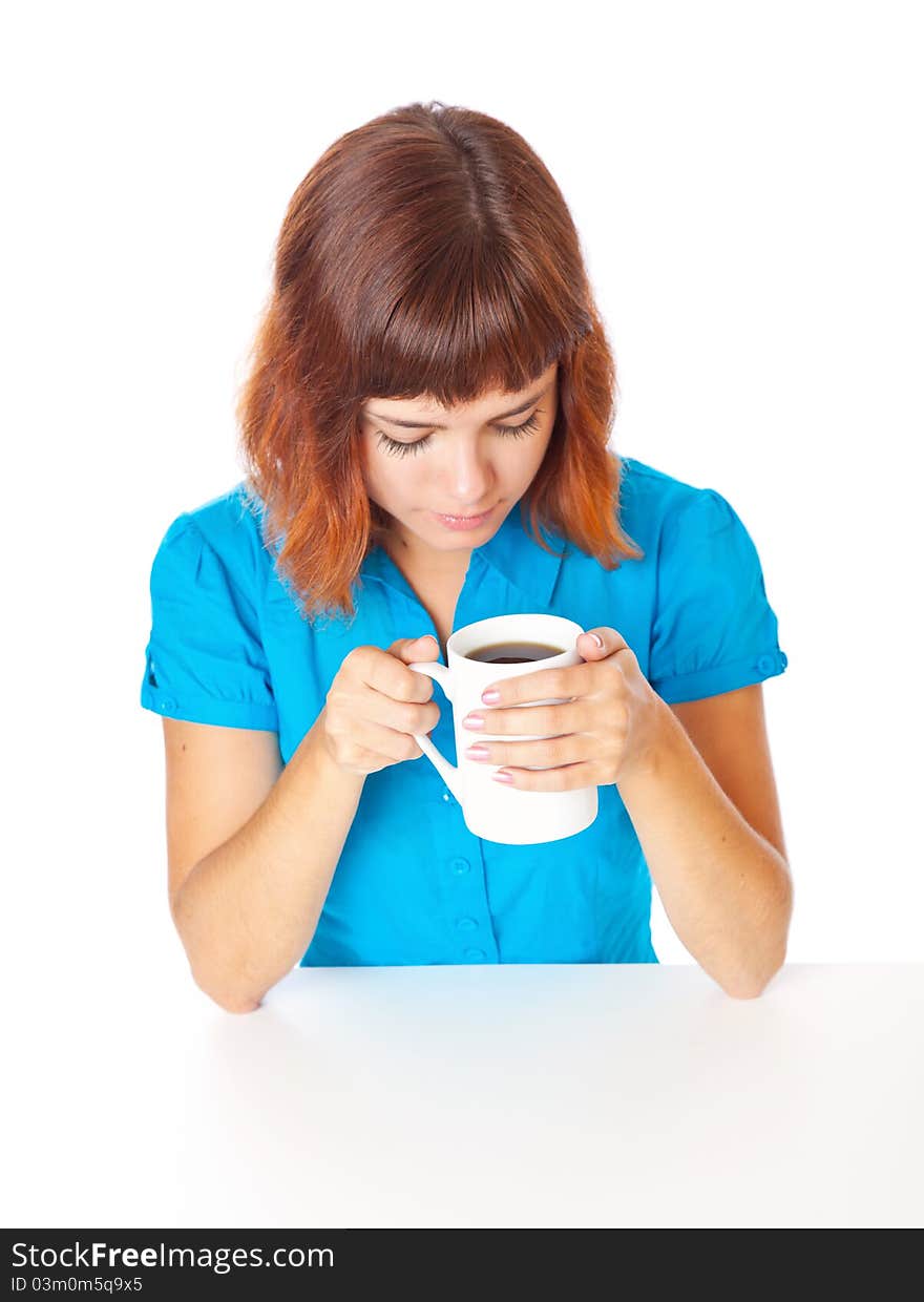 A smiling girl is drinking a coffee