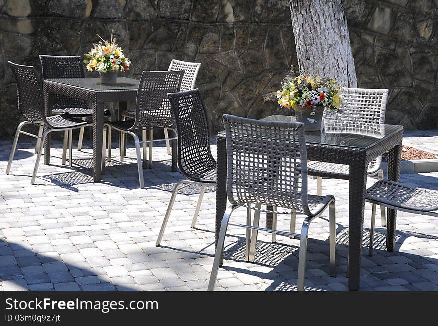 Two tables, bouquets and chairs.