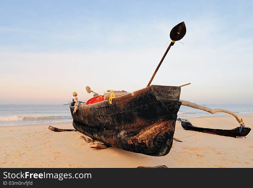 Wooden old fishing boat on the sandy shore. Wooden old fishing boat on the sandy shore