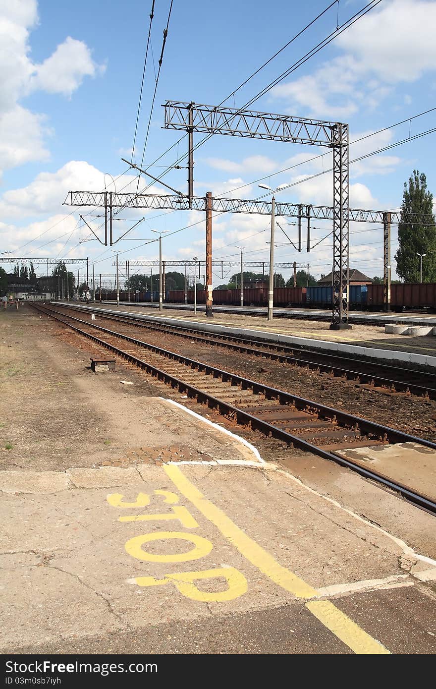 Empty train station with stop sign painted on the ground.