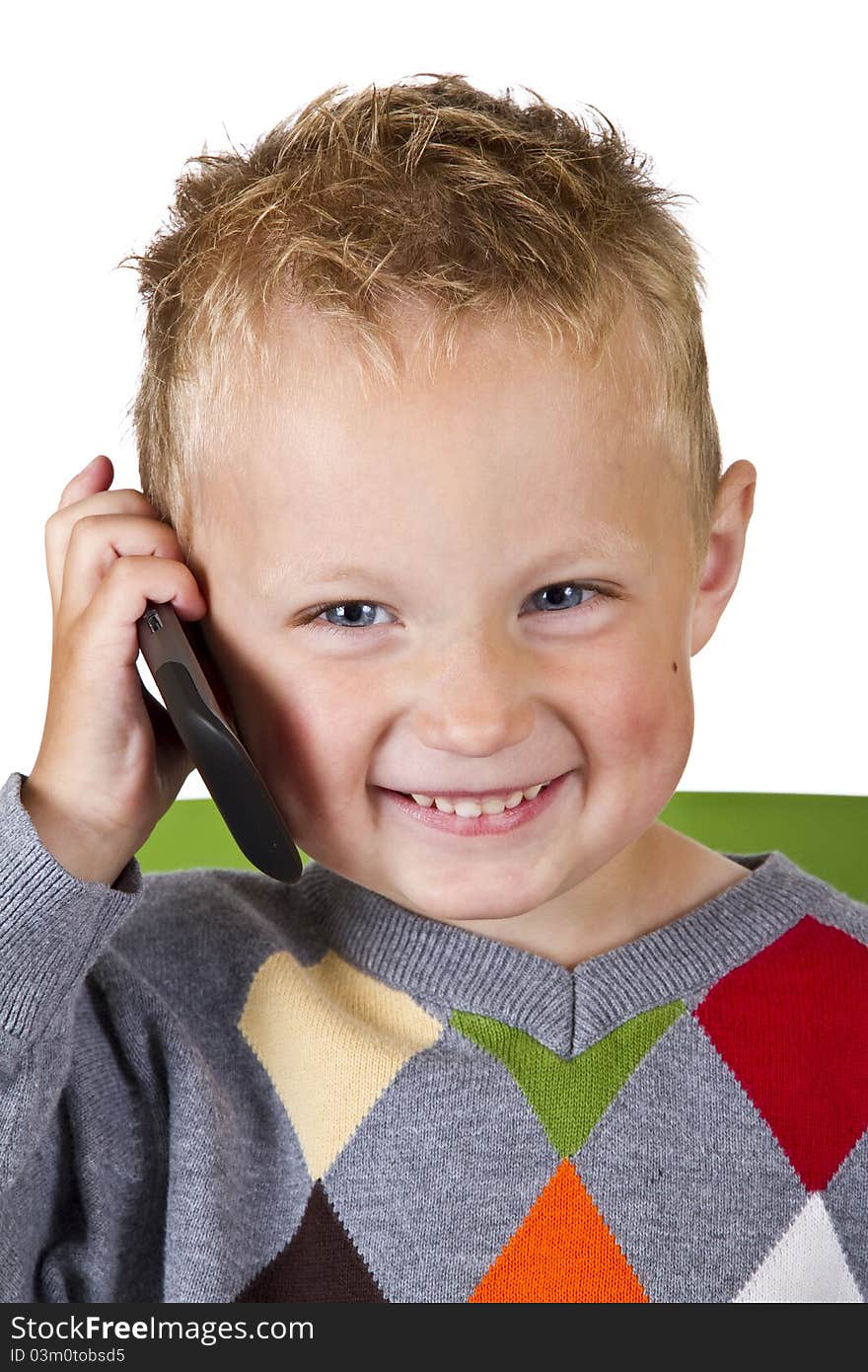 Three years old boy talking on a cell phone - isolated on white background