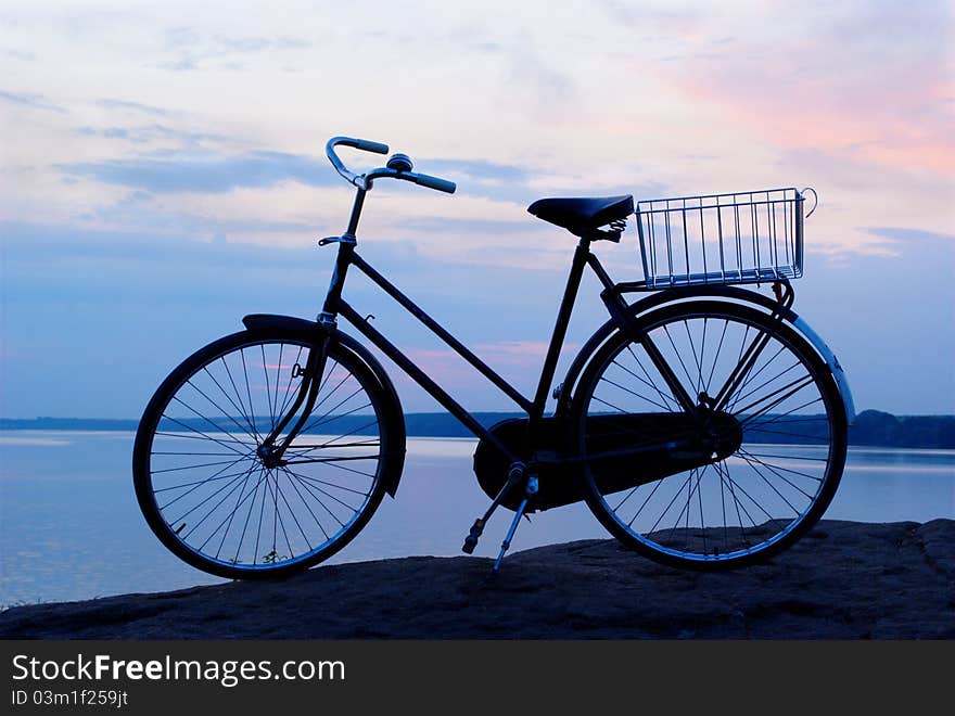 Bicycle on a background of beautiful blue evening sky. Bicycle on a background of beautiful blue evening sky