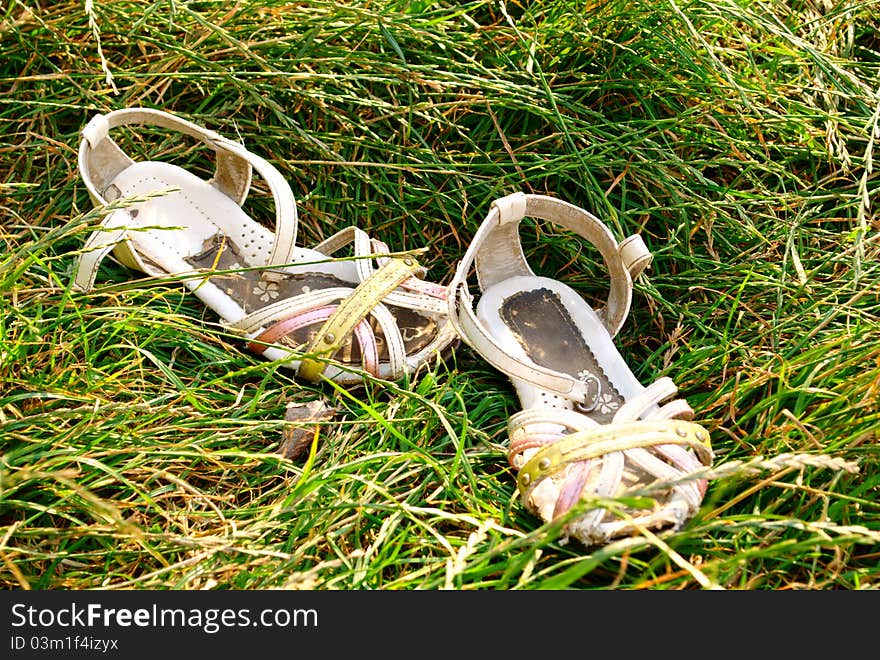 Children s sandals are worn in the grass