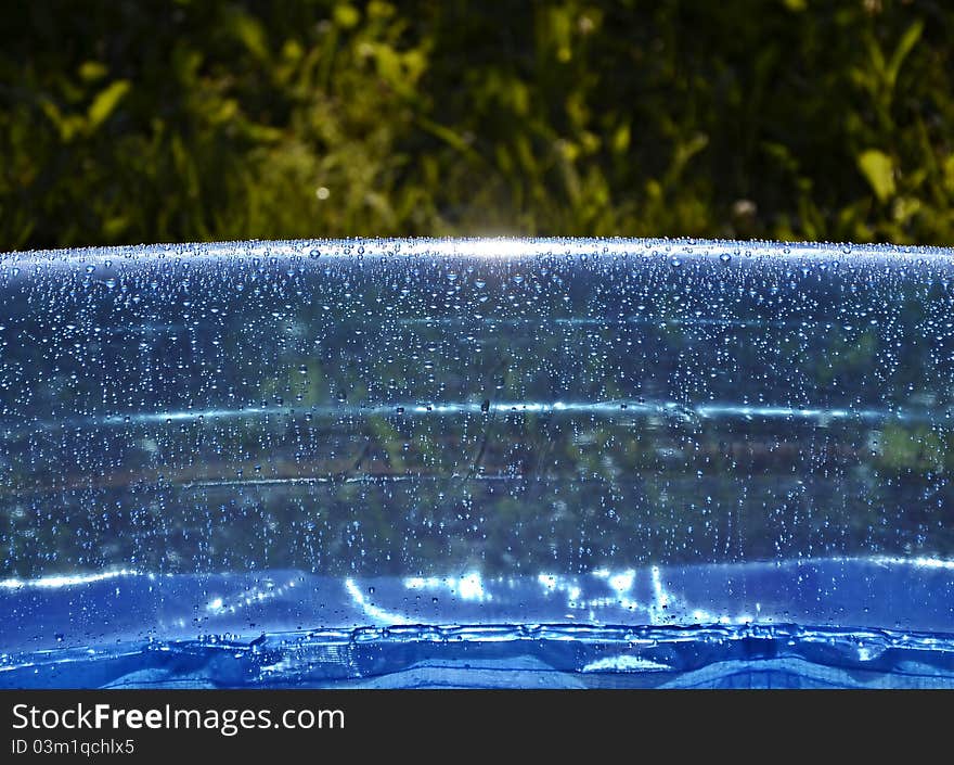 Blue inflatable swimming pool in garden. Blue inflatable swimming pool in garden