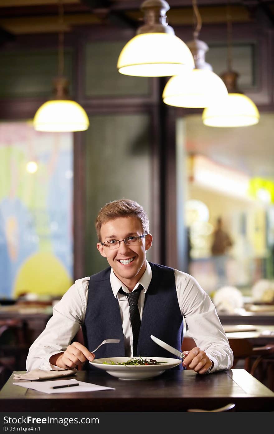 Young smiling man in a restaurant. Young smiling man in a restaurant