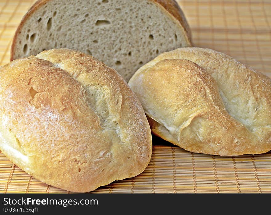 Bread and two rolls on table