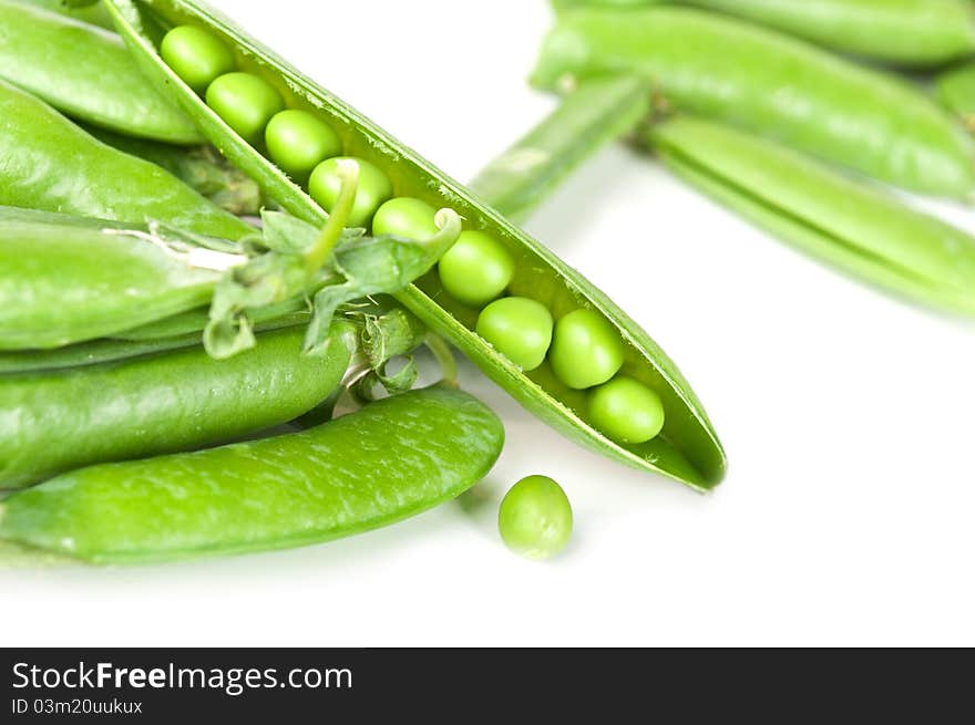 Fresh green peas isolated on a white background