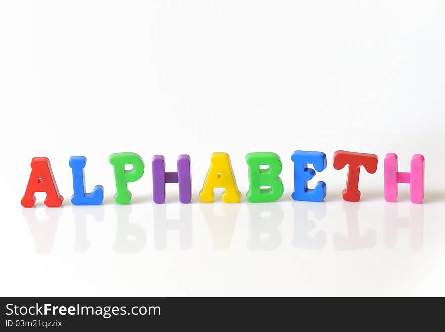 Colorful plastic toy letters isolated on white background