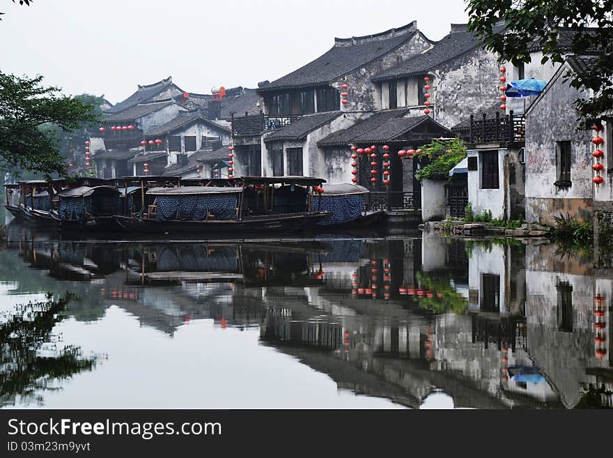 Old water town , some old boats on river， which  reflecte on the river. Old water town , some old boats on river， which  reflecte on the river