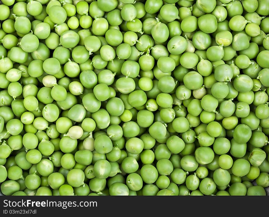 Fresh and green peas on a background