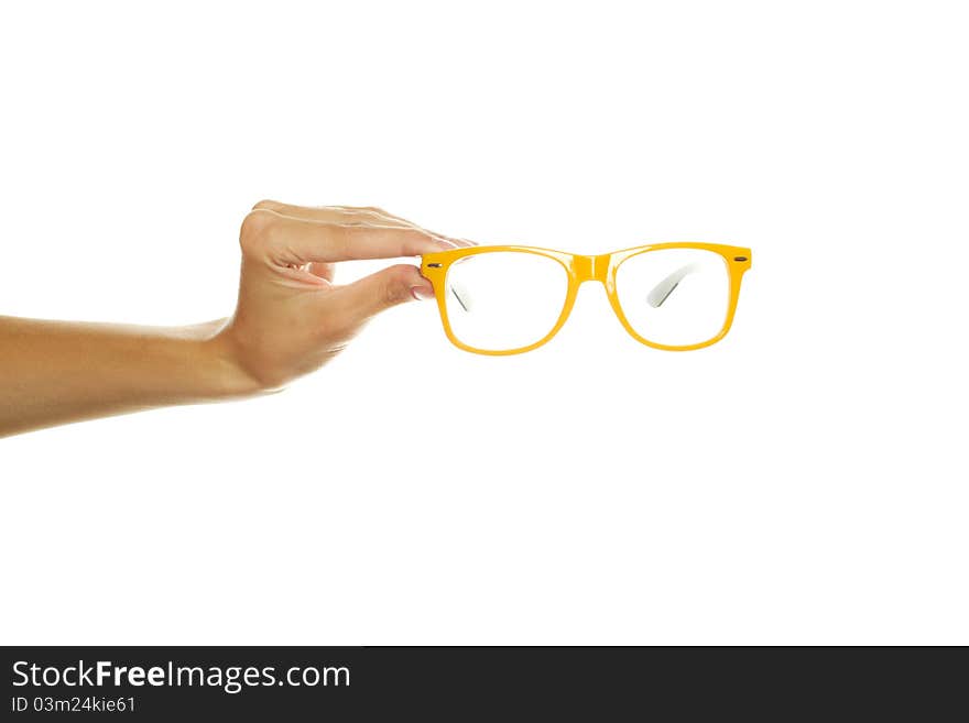 Close-up of female hand holding glasses. Isolated on a white background. Close-up of female hand holding glasses. Isolated on a white background