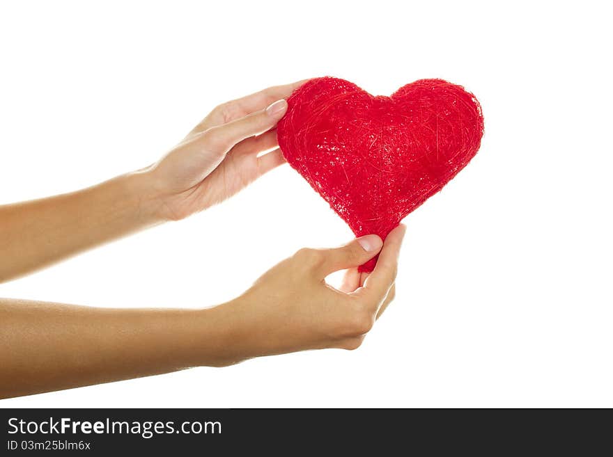 Close-up of female hand holding a red heart. Isolated on a white background. Close-up of female hand holding a red heart. Isolated on a white background