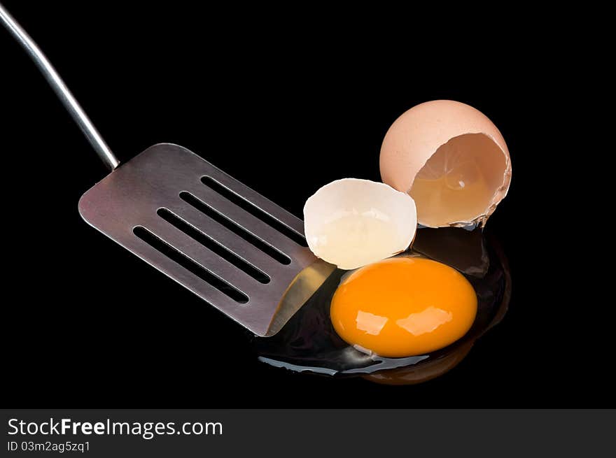 Broken egg isolated on a black background