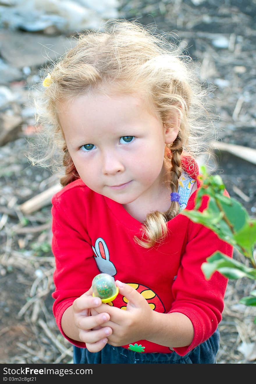 The little girl in red against abstract background. Shallow DOF