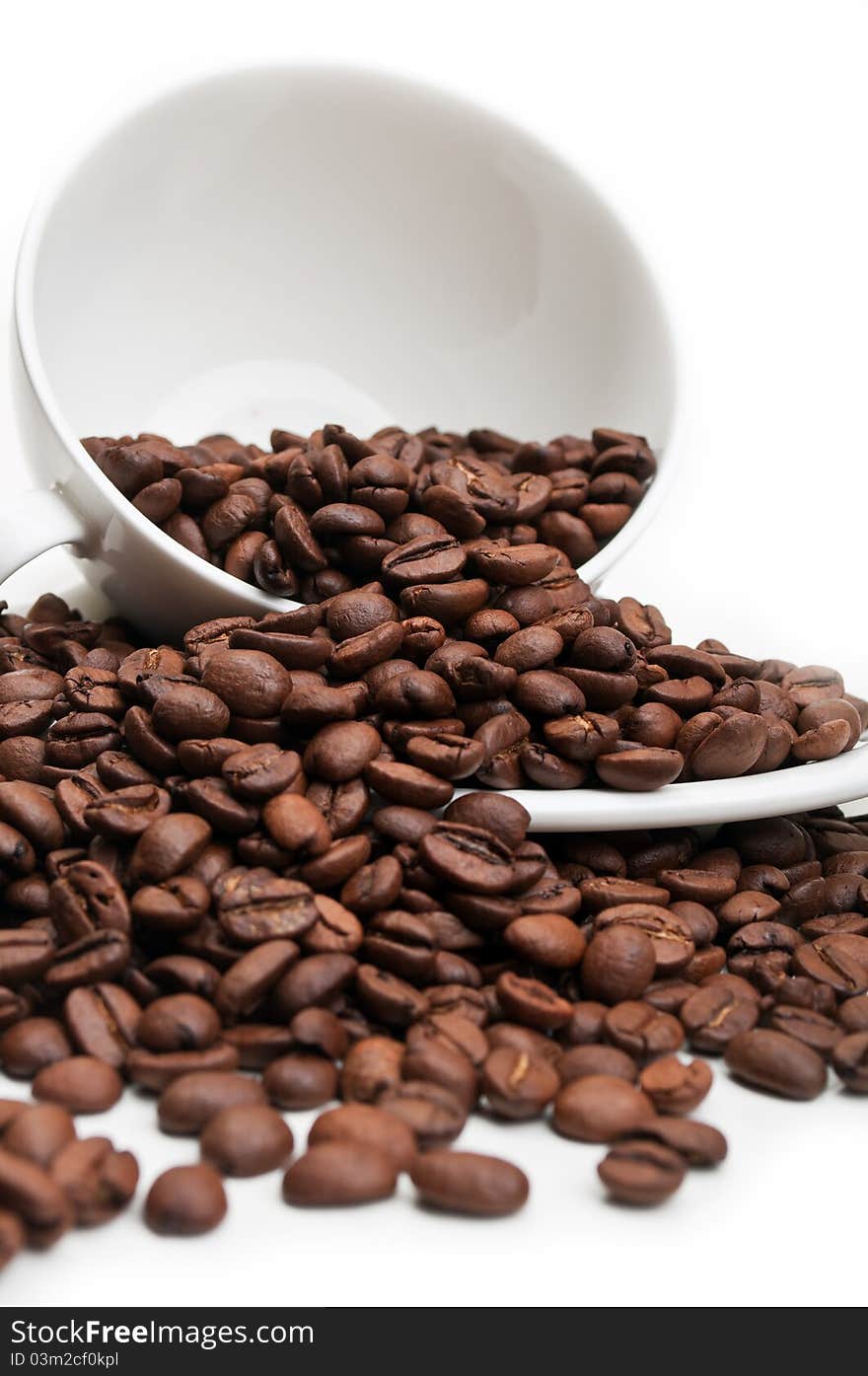 Full cup with coffee beans isolated on a white background