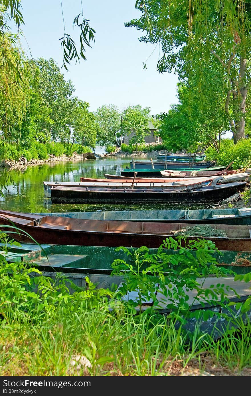 Anchored boats floating on water in small bay