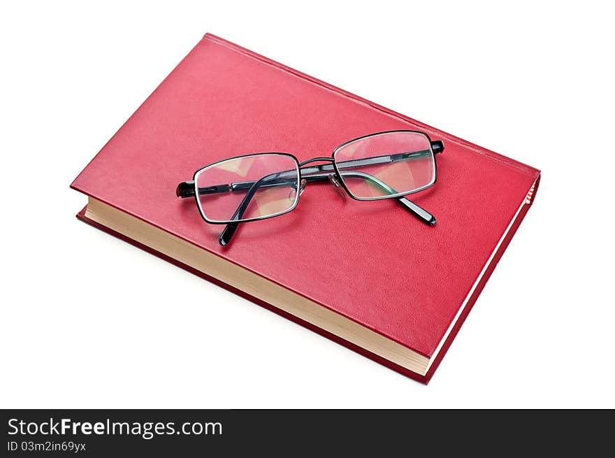 Glasses and red book isolated on a white background