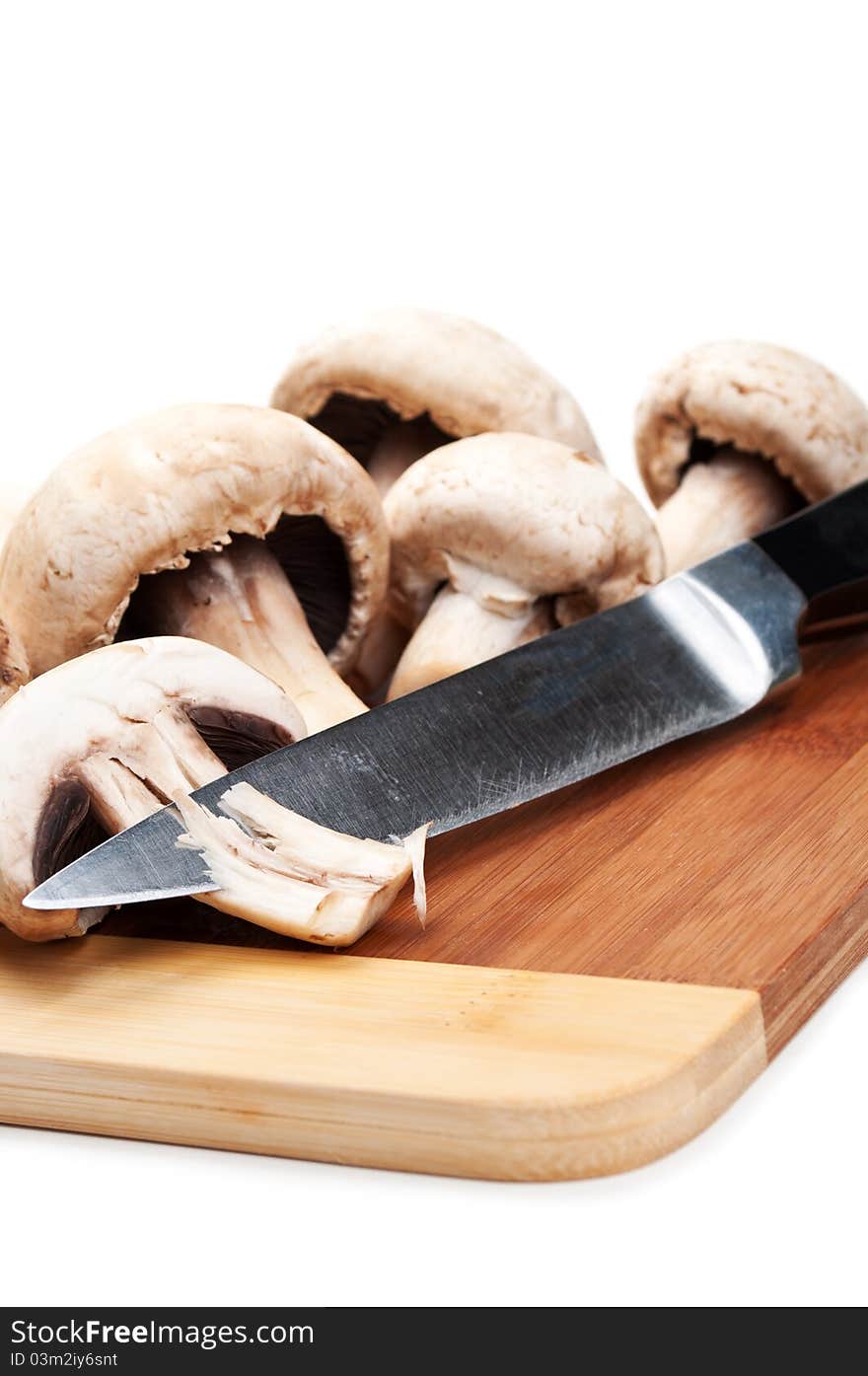 Fresh mushrooms and knife isolated on a white background