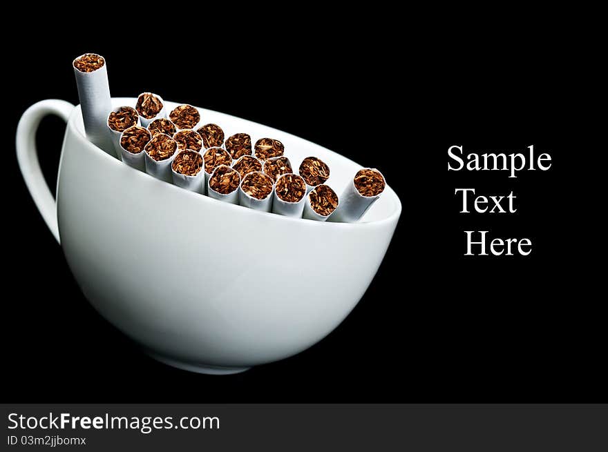 Cup full of cigarettes isolated on a black background