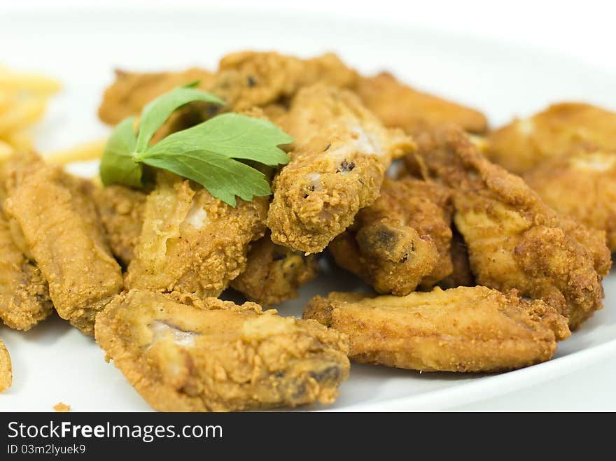 Golden fried chicken in a white plate