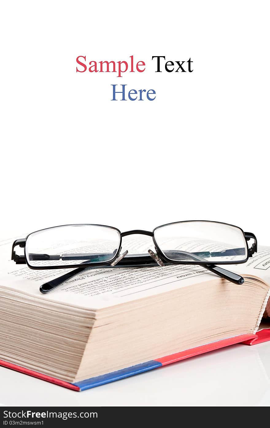 Big encyclopedia book and eyeglasses isolated on a white background