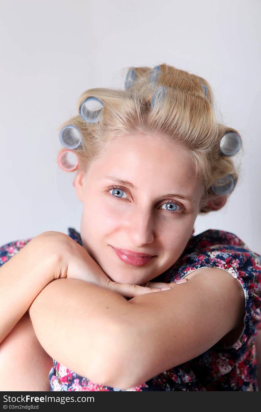 Young woman with hair curlers