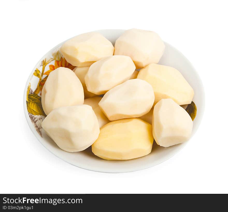 Pile of peeled potatoes on a plate, isolated