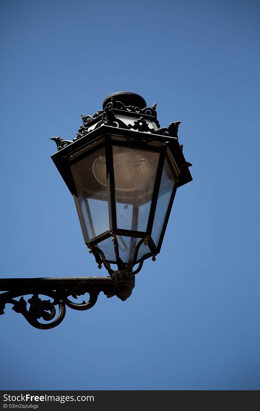 Metal lantern in front of blue sky on the day