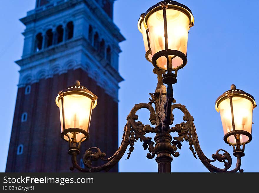 Venetian Bell Tower with lamp in evening