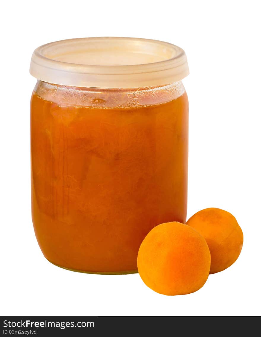 Tasty and healthy apricot jam jar on a white background with two apricots.