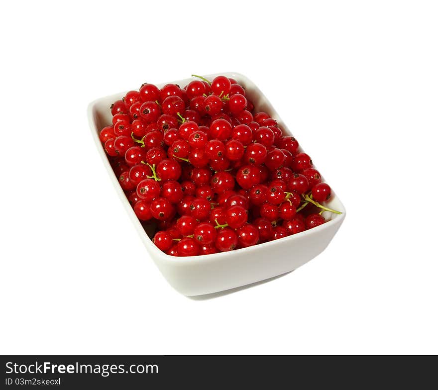 Fresh red currant berry in a plate at white background. Fresh red currant berry in a plate at white background