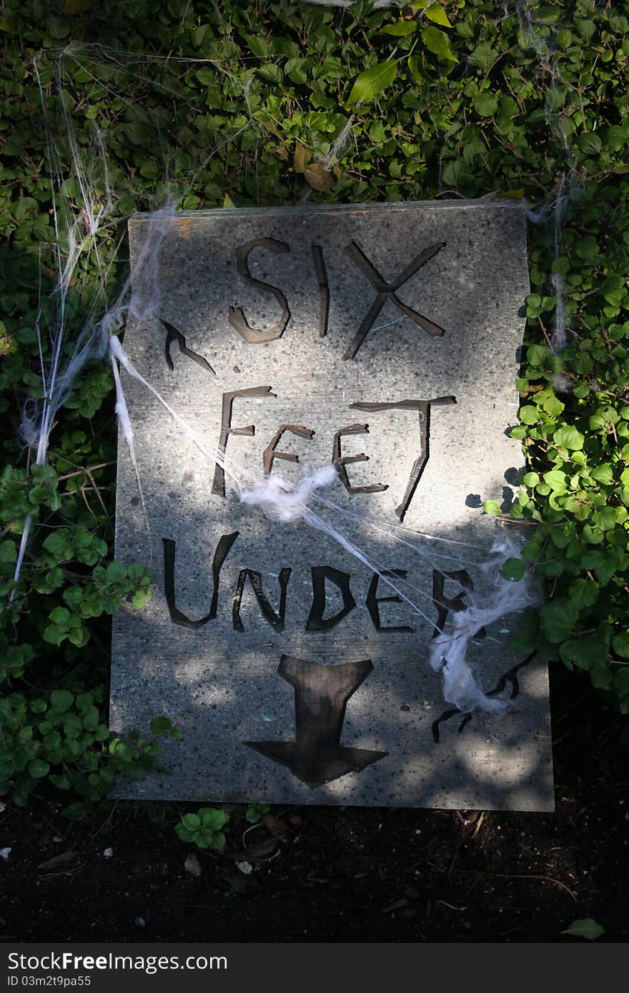 A Tombstone, chiseled 'Six feet under'. A Tombstone, chiseled 'Six feet under'