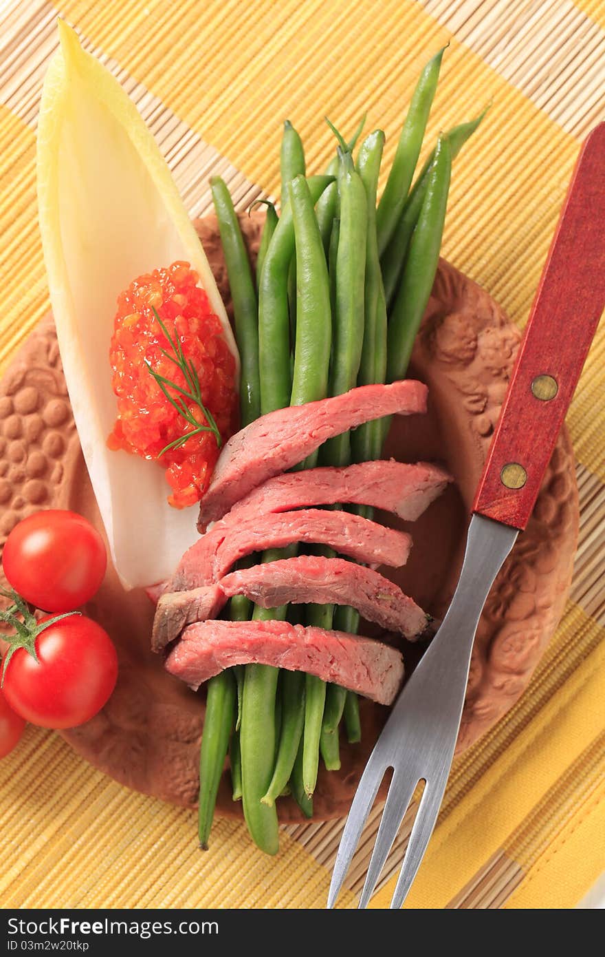 Strips of roast beef  and vegetables