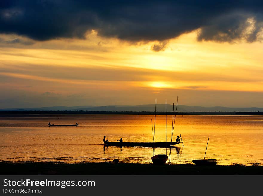 Silhouette of children on wood boat at sunset. Silhouette of children on wood boat at sunset