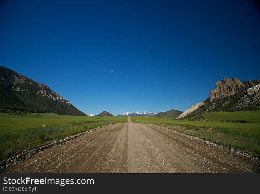 A gravel roads splits the wilderness of northern Wyoming. A gravel roads splits the wilderness of northern Wyoming.