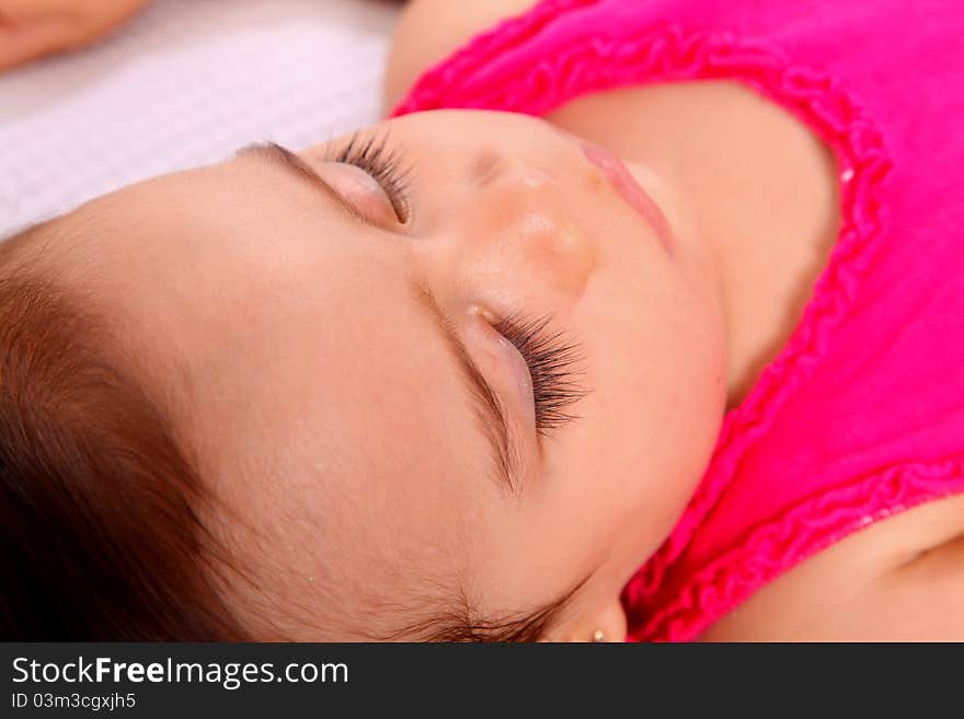 Sleeping baby girl with pink drees