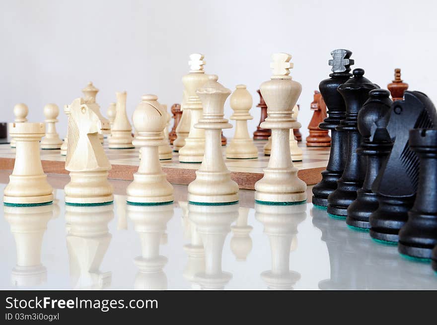 Chess Pieces On Wood Board