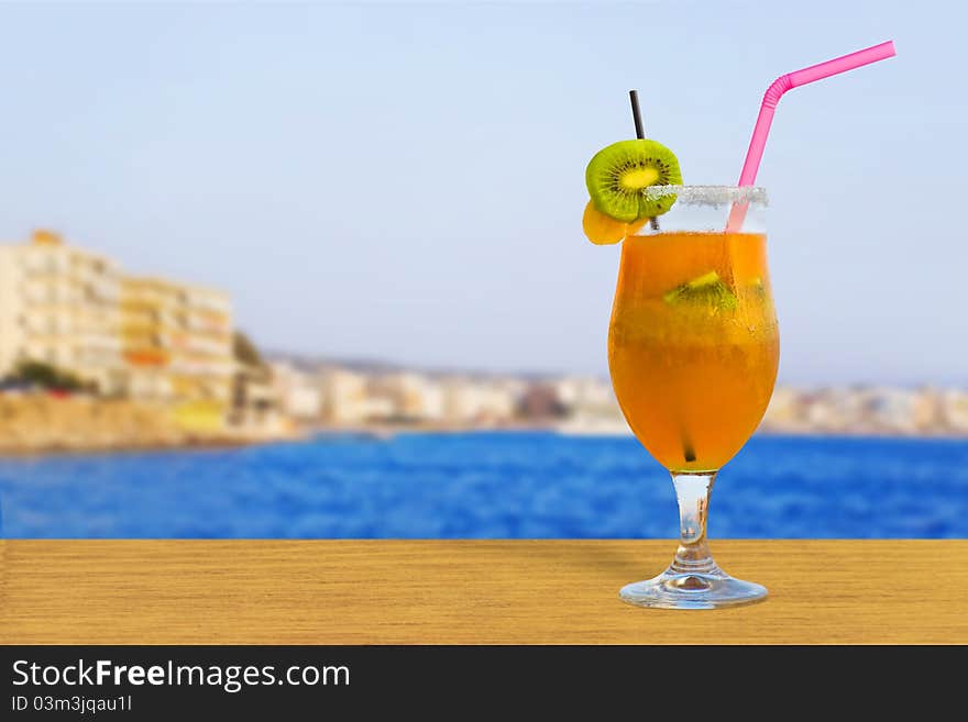 Cocktail on table in cafe - sea and town on background