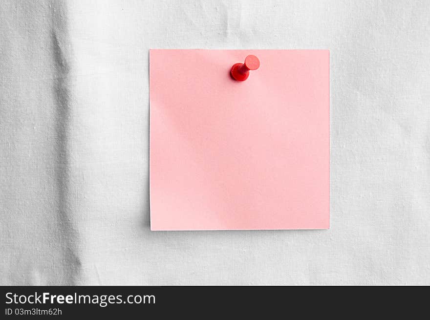 Pink note with red pin on white sheet - love message