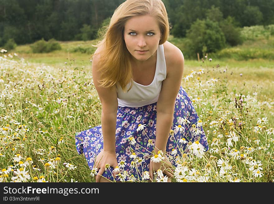 Pretty girl relaxing outdoor in grass