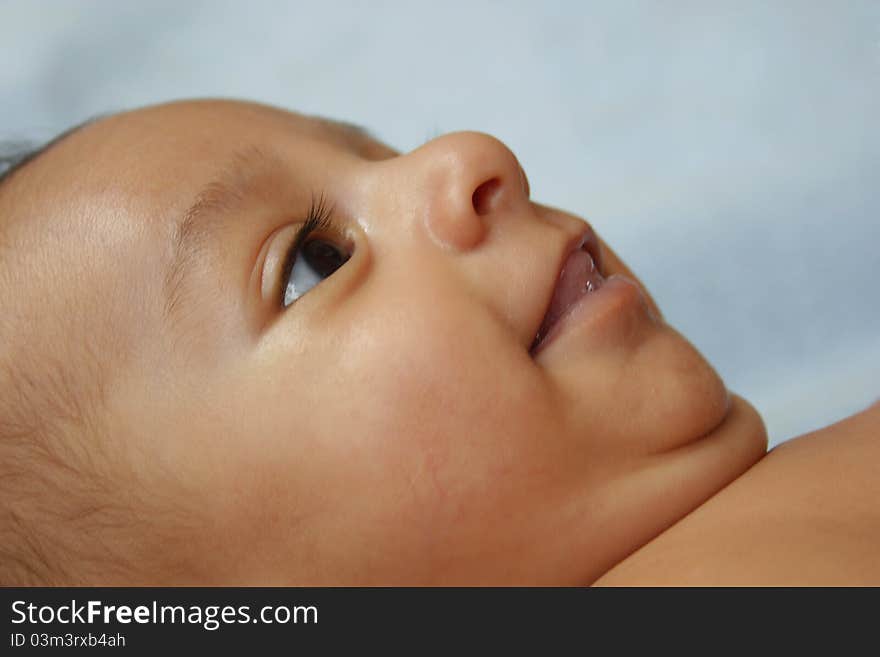 Side view closeup of a few months cute baby child