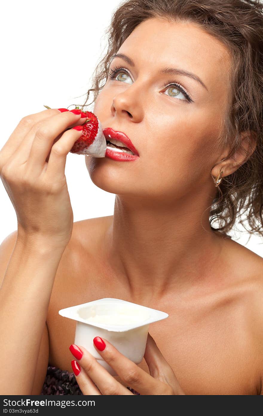 Portrait of young female enjoying taste of strawberry with yogurt, isolated on white background. Portrait of young female enjoying taste of strawberry with yogurt, isolated on white background