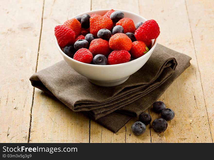 Photo of mixed fresh berries on wooden table