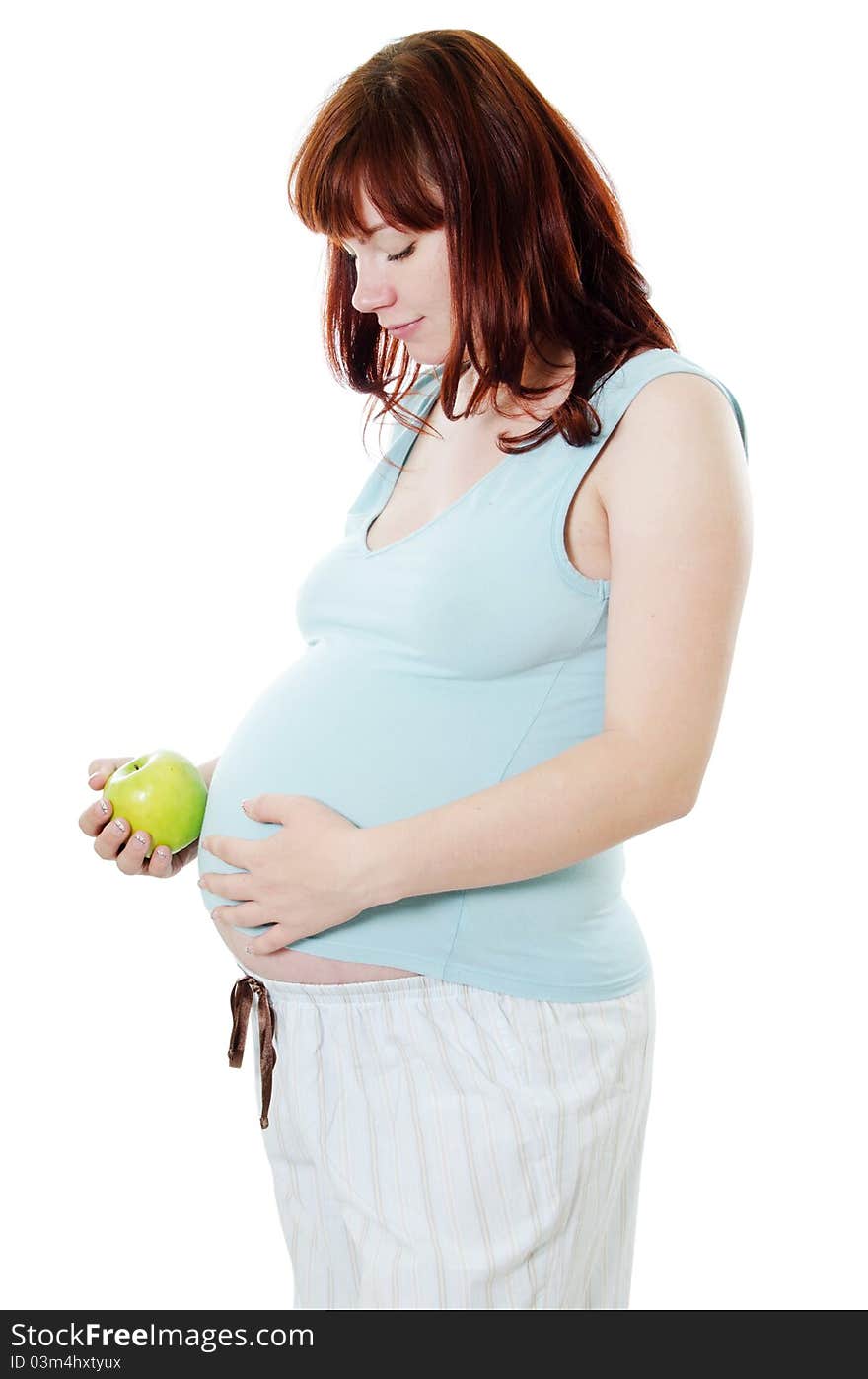 The pregnant woman with an apple on white