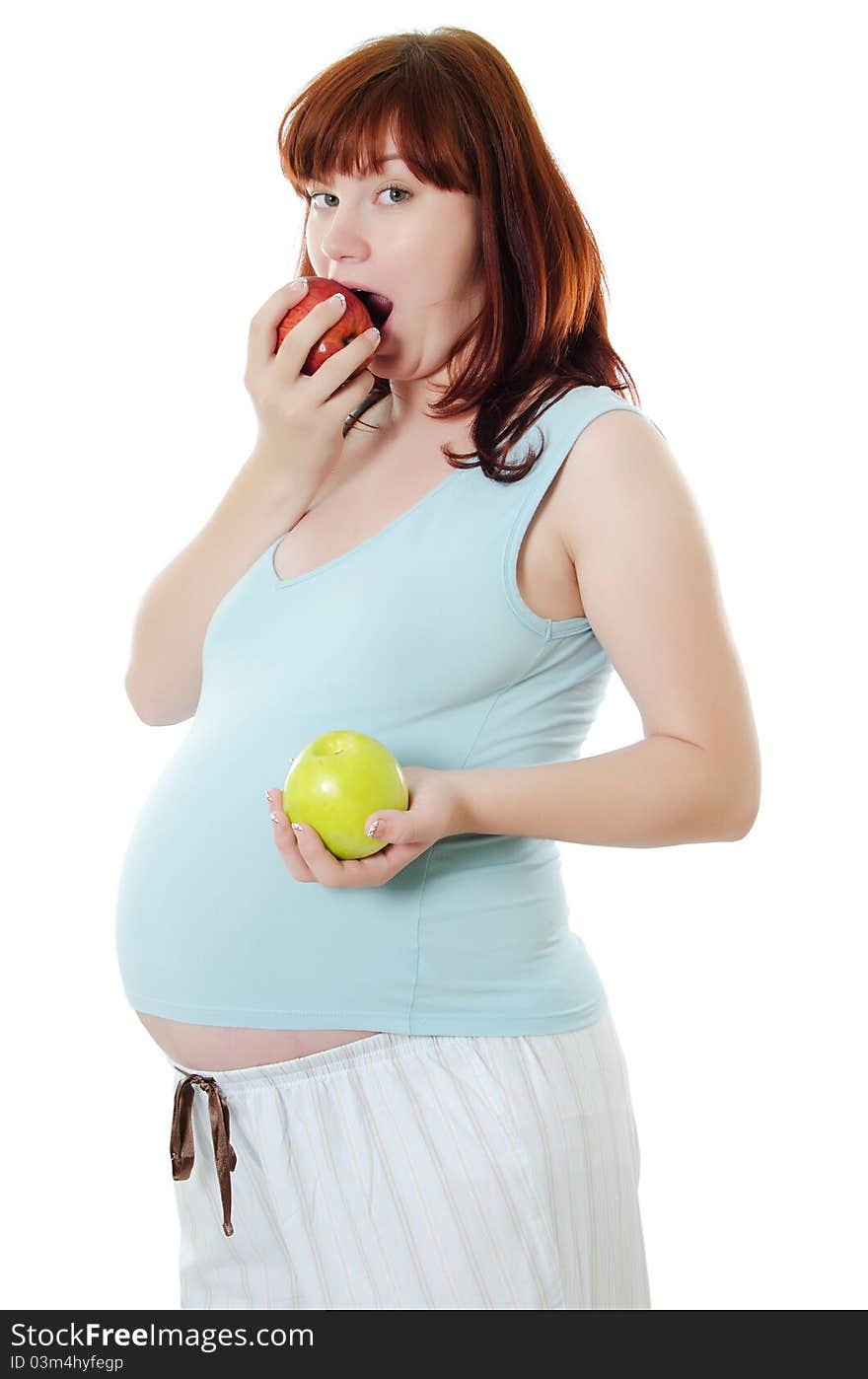 The pregnant woman with an apple isolated on white