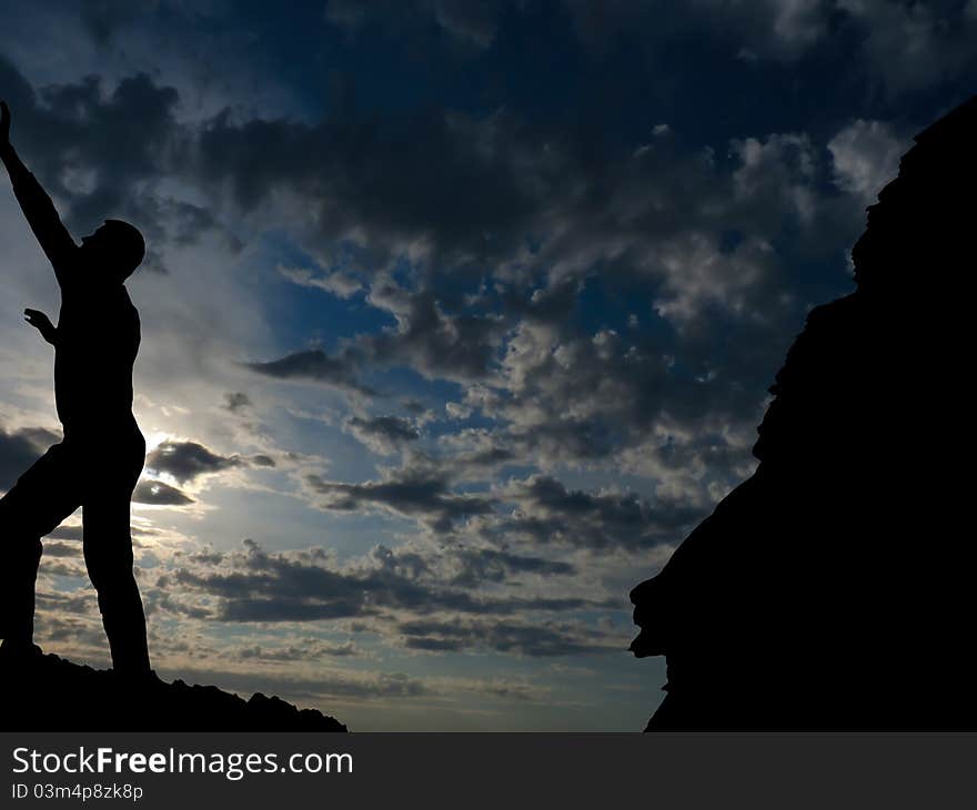 Rock climber conquers mountain against the sky