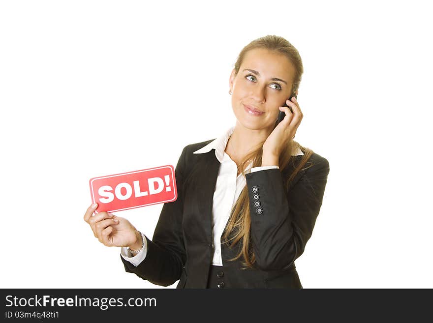 Attractive modern business woman talking on the phone and keeps the card SOLD in your other hand. isolated. Attractive modern business woman talking on the phone and keeps the card SOLD in your other hand. isolated